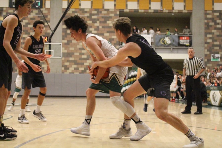 Senior Dylan Rossi snatches the ball from his defender. 