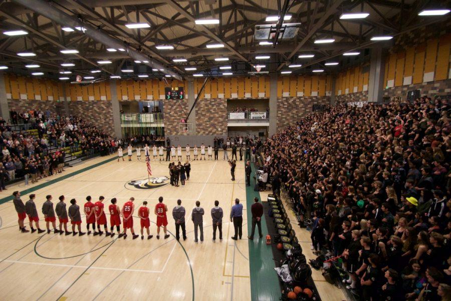 Bobcat Nation stands in unison for the singing of the national anthem. The student section repped their blackout dress theme of a Star Wars atmosphere.