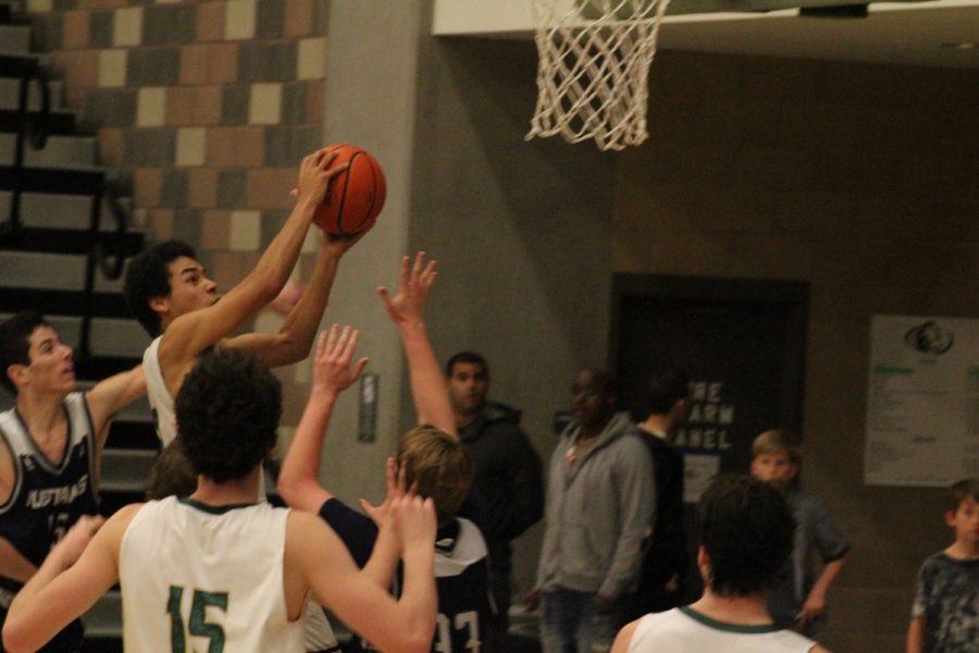 Point guard, Xavier Allison drives through the Mustang defense for an easy layup.