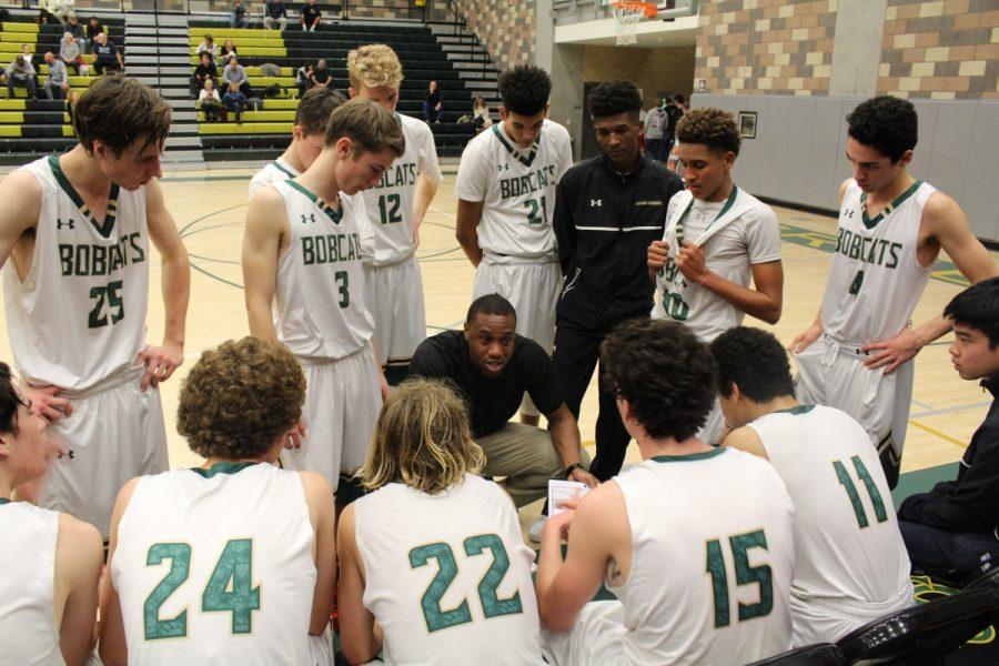 Bobcat players meet during a timeout to strategize for the fourth quarter.
