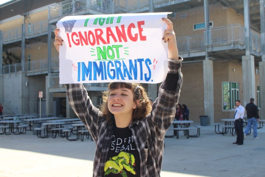 Sophomore, Skylar Johnson, carries a sign that says, "Fight ignorance, not immigrants."