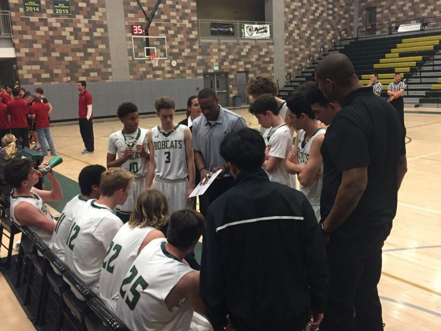 Coach Brandon Dowdy rallies his team in a meeting during a high scoring fourth quarter in the loss against Torrey Pines.