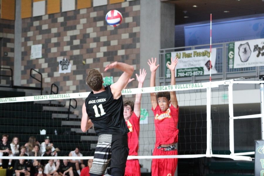 Junior Christian Janke soars above the net in preparation for a kill.