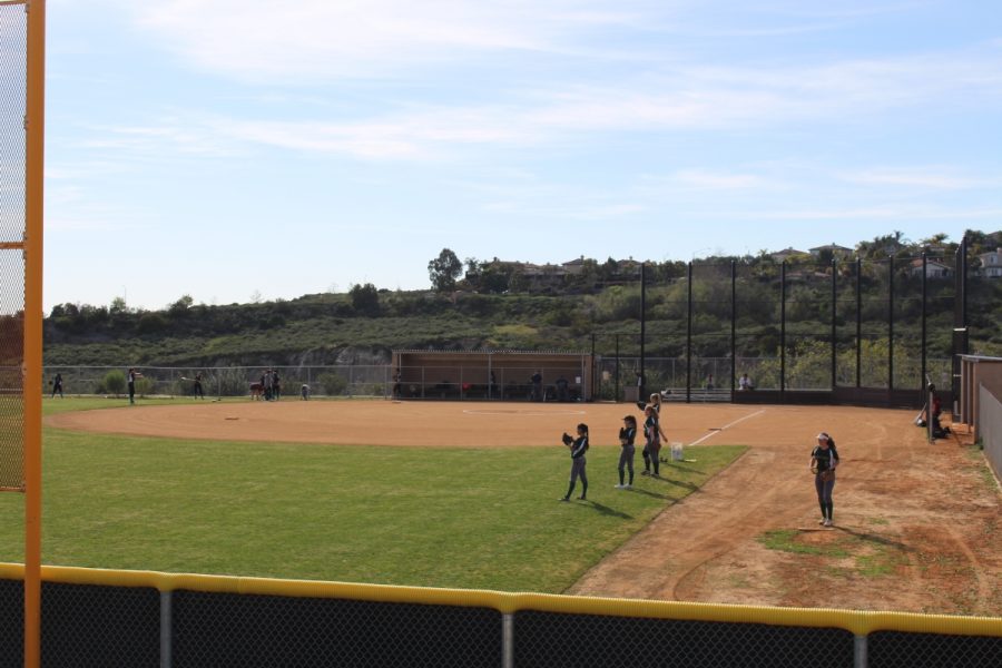 Softball teams share the field in preparation for the 2017 spring season.