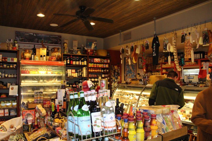 Bottles of Wine, boxes of chocolates, and bags of Italian chips scour the tiny market place, as customers walk in with a smile on their face from ear to ear.  
