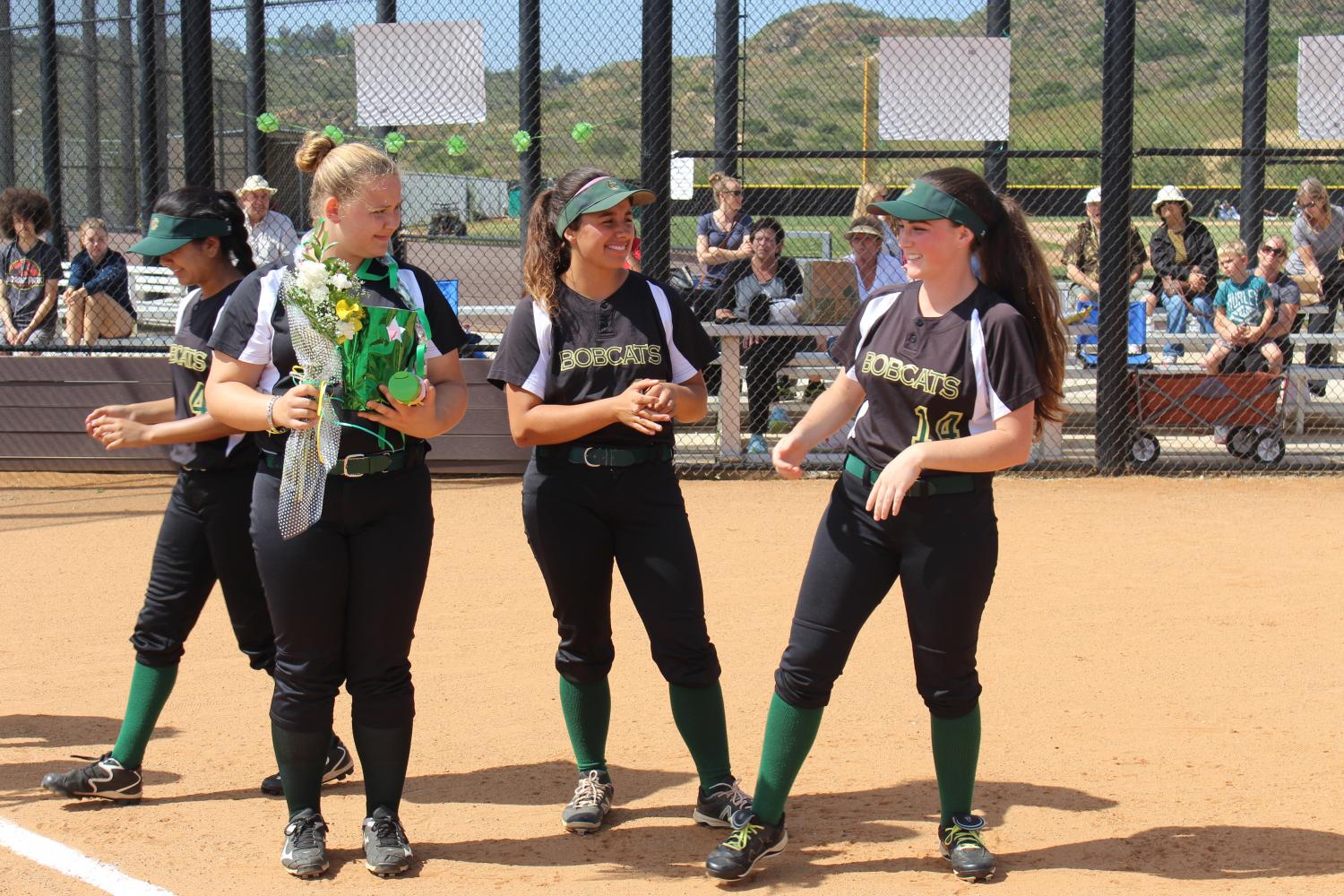 Seniors Amy Benkovich, Ariana Granda and Madison Surrency celebrate their last softball game as Bobcats. 