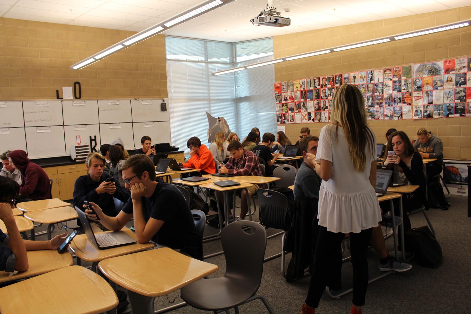 Students choosing to look at their phone during teacher lecture. 
