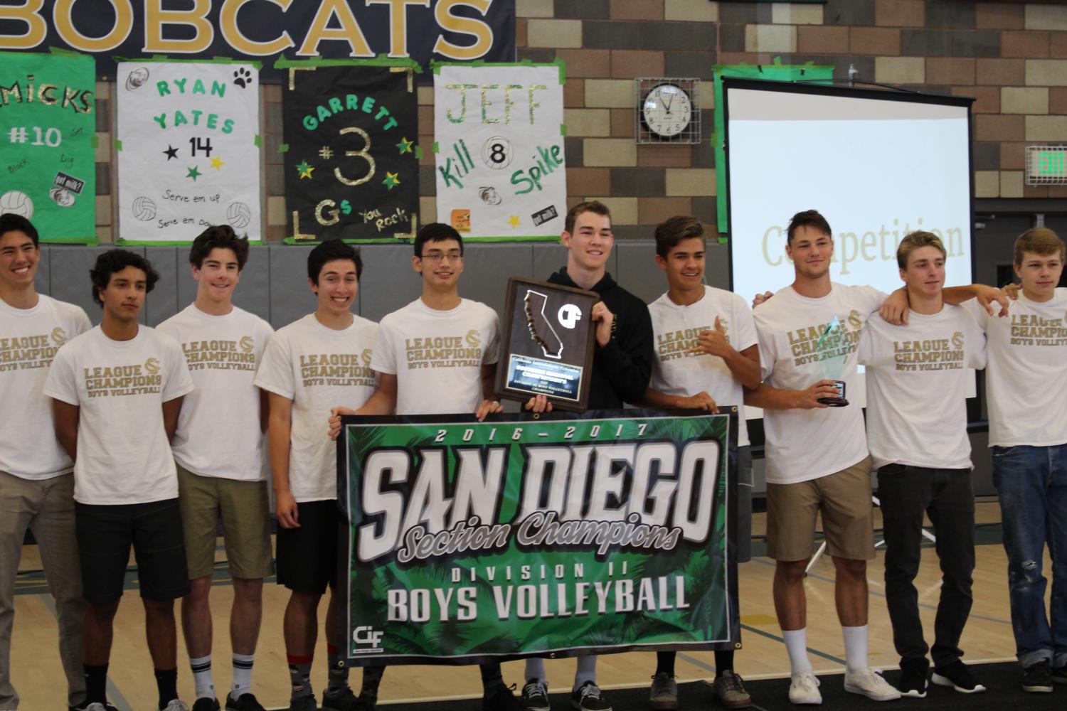 Boys Varsity Volleyball team stands united with their State Championship banner.