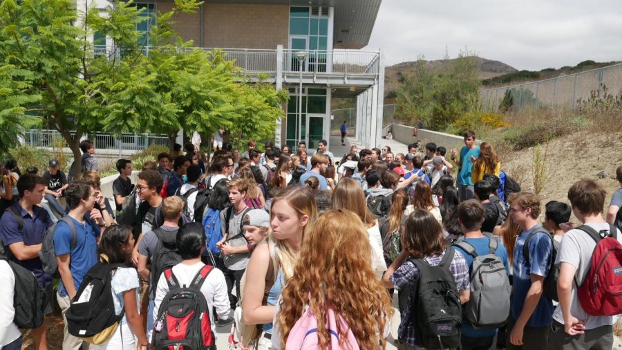 The senior class gathers at the top of the stairs to learn more details on senior assassins.