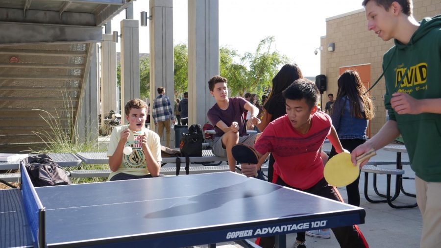 Fellow Bobcats participate in an intense ping pong match.