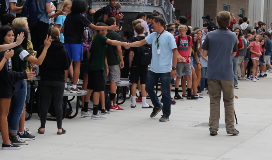 Well known for teaching since the school's first year, physics teacher James Fieberg high fives students during his "walkoff" to accept his award.