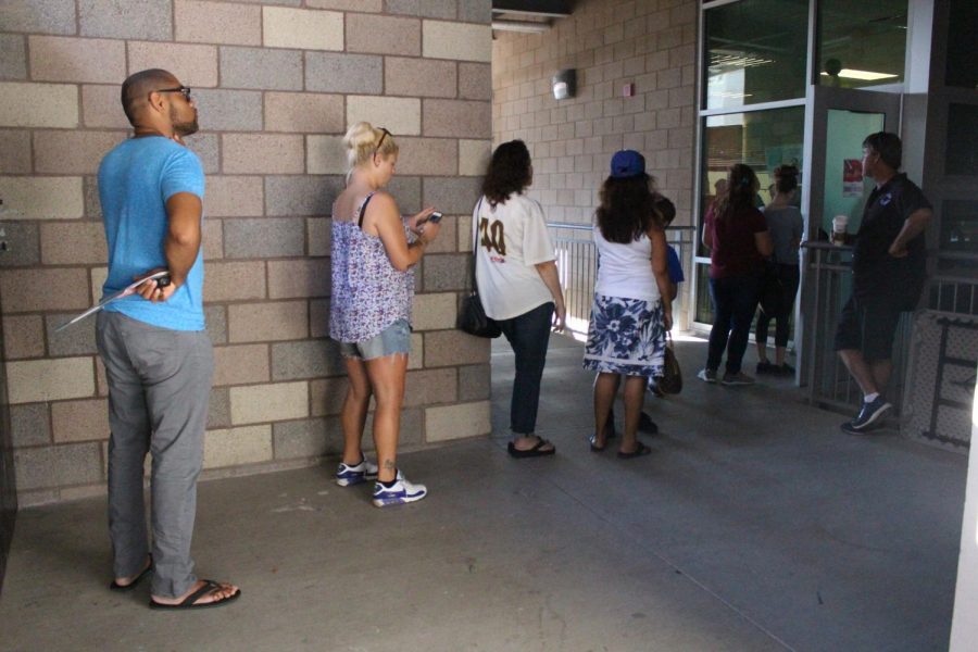 A line wraps outside of the art classroom as people wait to get their tickets.