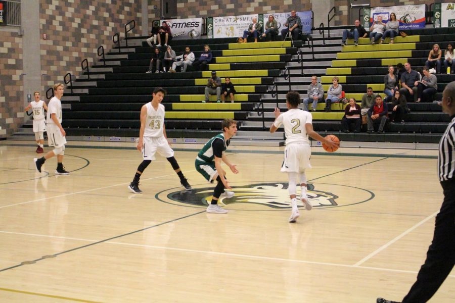 In a brief time out the boys varsity basketball team regroups. They were able to focus and eventually win the game against Mission Vista.