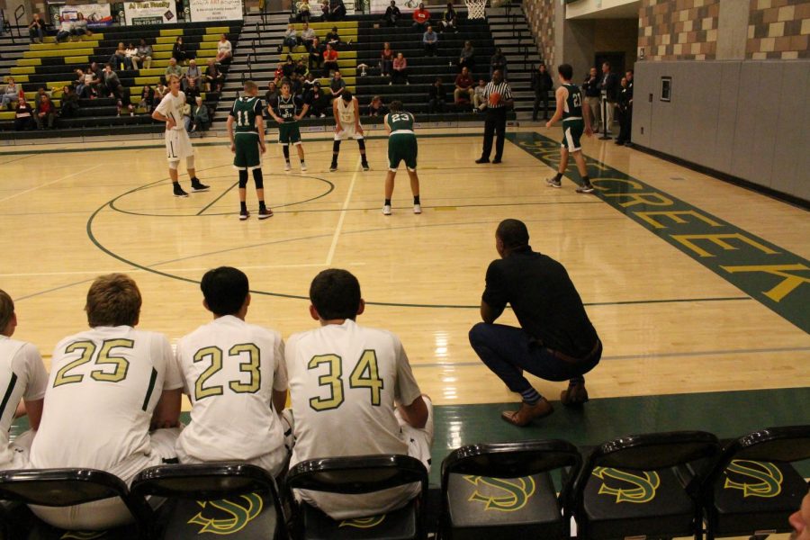  In the last few seconds of the game the varsity coach buckles down and holds on as Nick Zonk shoots a free throw. The continuous shots being made in the last half is enough to push the bobcats to the top allowing them to take home the win. 
