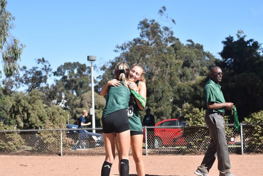 Brooklynn Deal (junior) embraces teammate, Natalie Huestis (sophomore) once receiving her 1st place team medal after racing 19:45 at the San Diego CIF Cross Country Championships. After three long seasons of racing Cross Country, this accomplishment had overjoyed Deal with all of the hard work that she had devoted to the sport throughout her high school career.
