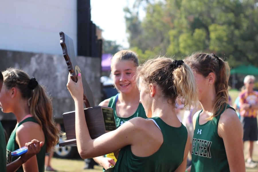 Elizabeth Gerhardt holds the second place trophy for the CIF state cross country meet. Gerhardt came in 39th place within the 195 girls in her league. The Sage Creek girls cross country team took home this trophy after a successful season full of accomplishments.
