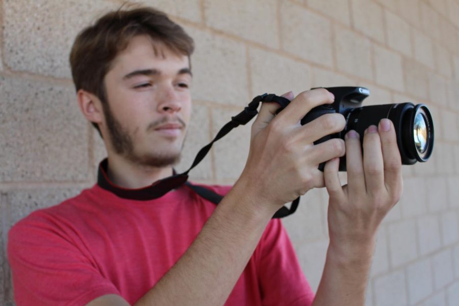 Chris Beauchamp preps the camera to get ready for the filming of a self produced film. 
