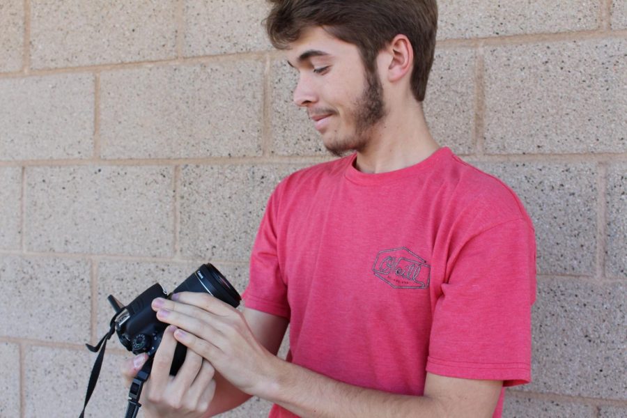 Chris Beauchamp preps the camera to get ready for the filming of a self produced film. 
