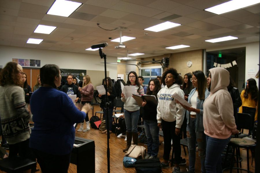 Dylan Goecke, Emily Parra, and Levi Folck practice their part of the alma mater. This is the
first year of having a choir class.