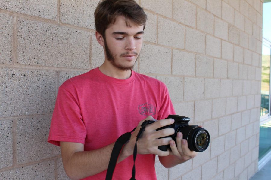 Chris Beauchamp preps the camera to get ready for the filming of a self produced film. 
