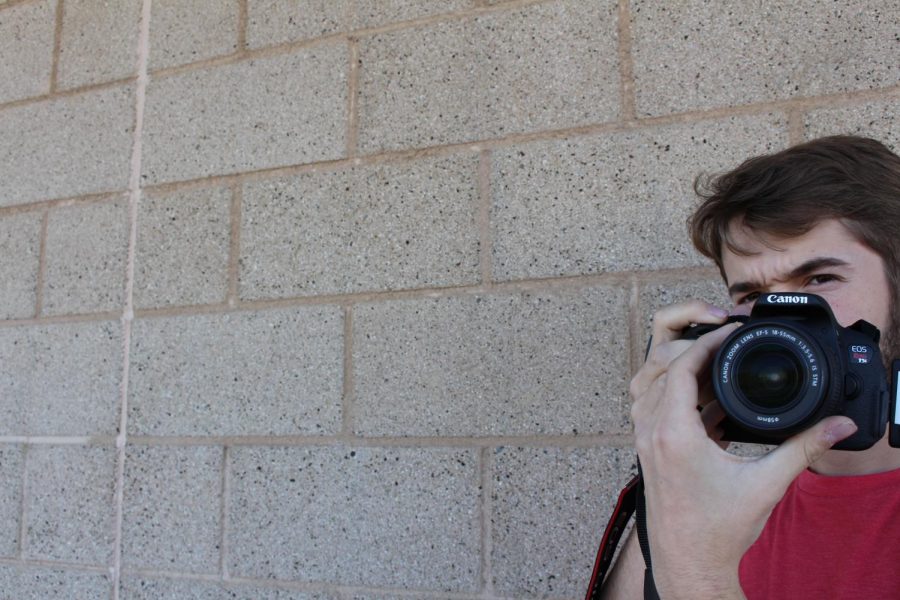 Chris Beauchamp preps the camera to get ready for the filming of a self produced film. 
