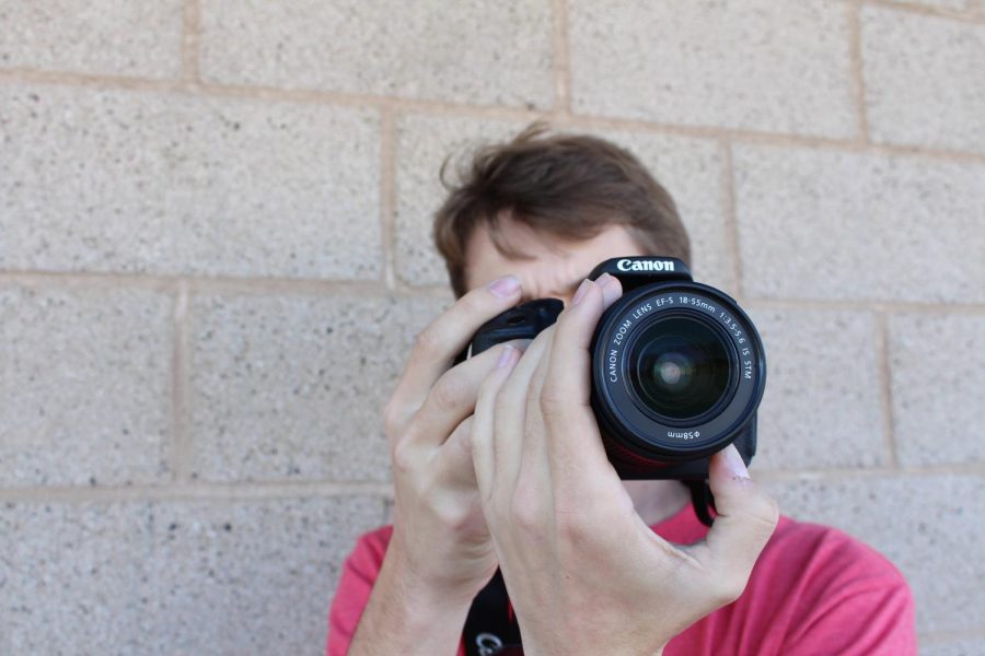 Chris Beauchamp preps the camera to get ready for the filming of a self produced film. 
