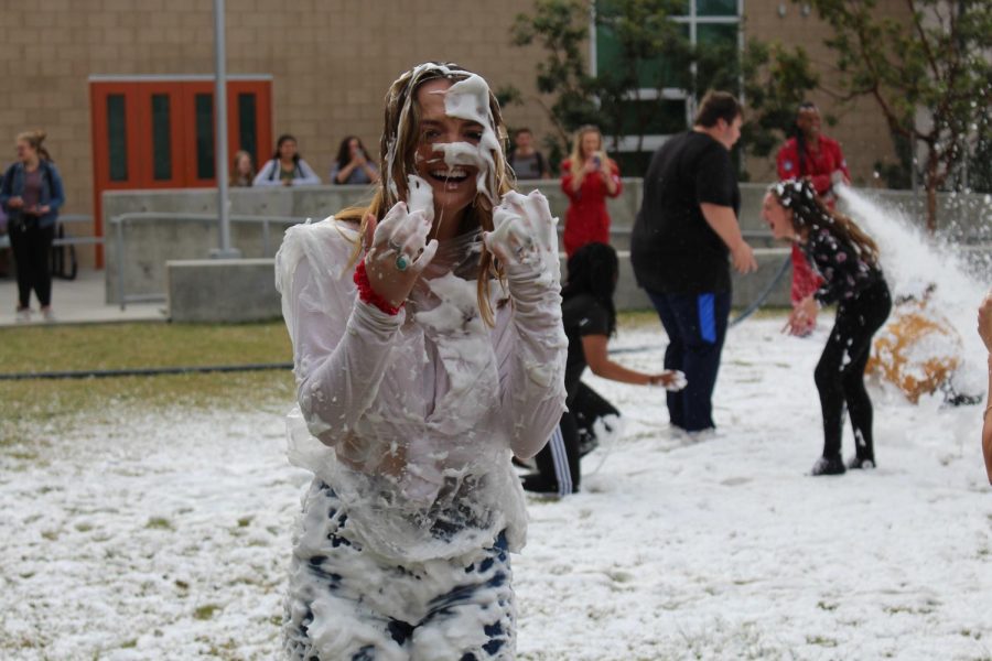 Although senior Paige Loeffler appears to be covered from head to toe in soap, she continues to laugh and smile through the event before heading to fourth period.