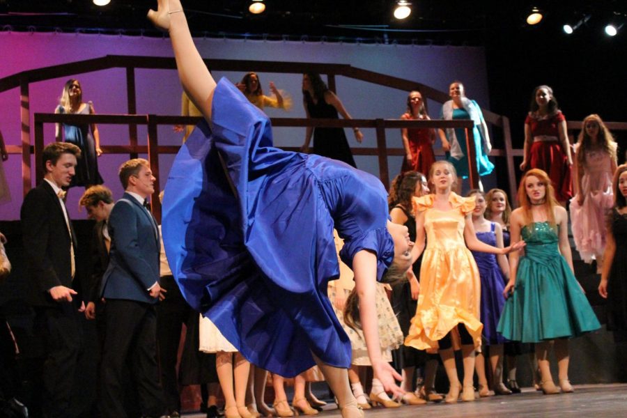 During the final number, "Footloose", amidst all the excitement and chaos, a solo dancer is captured gracefully extending her leg into the air.