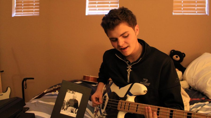 Senior Tyler Overbey with his autographed picture of George Martin, producer of The Beatles.