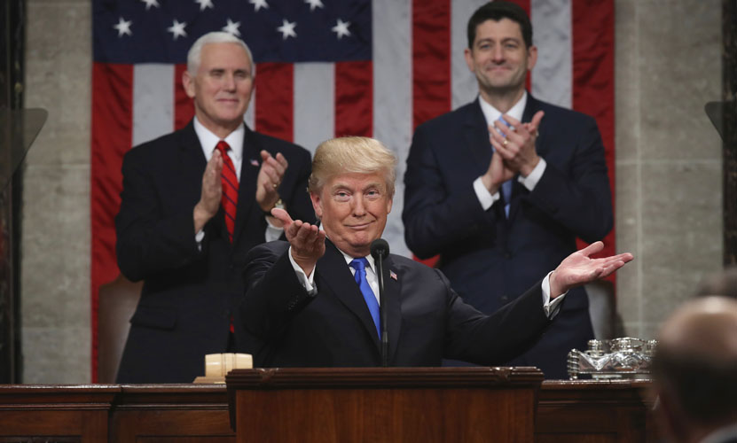 President Donald Trump gestures as delivers his first State of the Union address in the House chamber of the U.S. Capitol to a joint session of Congress Tuesday, Jan. 30, 2018 in Washington, as Vice President Mike Pence and House Speaker Paul Ryan applaud. (Win McNamee/Pool via AP)