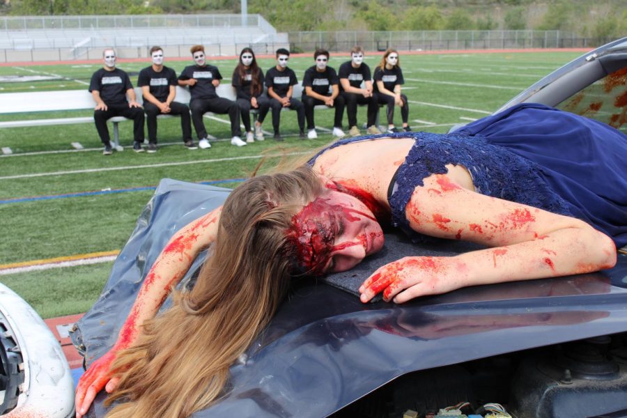 Summer Fitzgerald, a junior at Sage Creek, is displayed laying on the hood of a crashed vehicle for the Every 15 Minutes scene, put on by nine of our very own students.