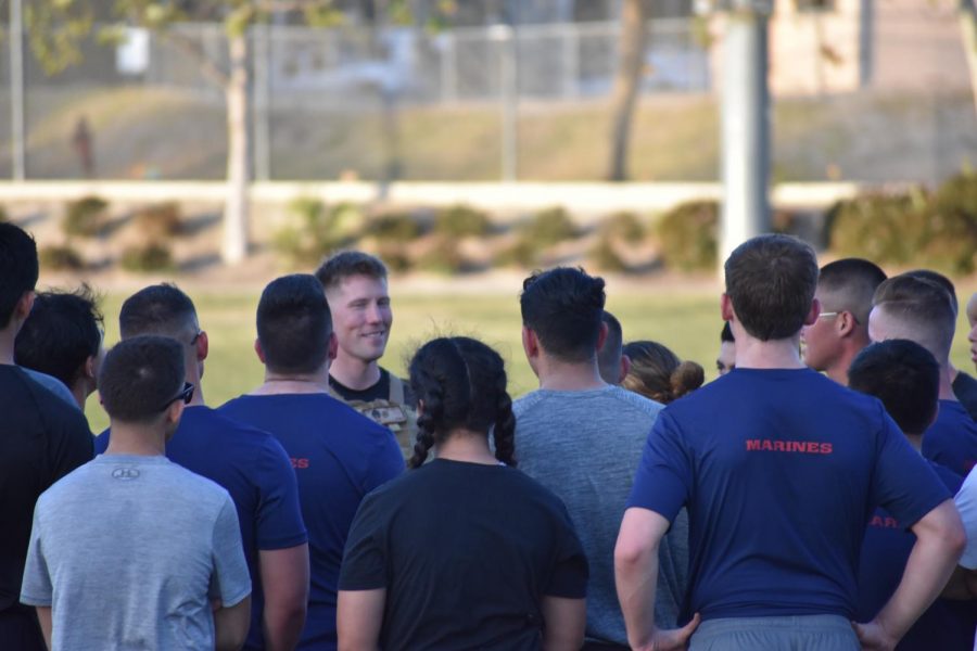 The sergeant smiles proudly at his recruits after a tough training session.