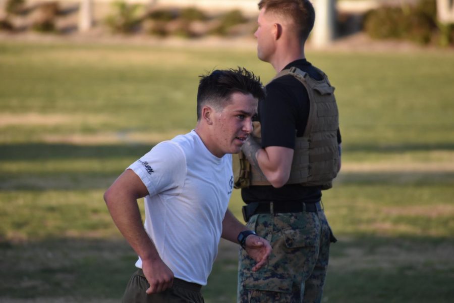 A recruit finishes off a lap around the field.