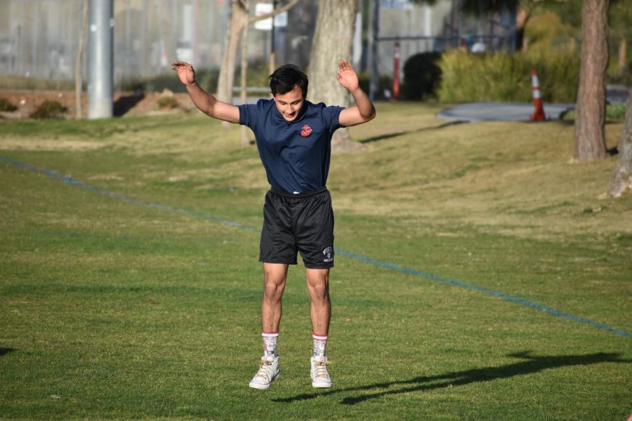 A recruit jumps into the air as he completes a burpee. 