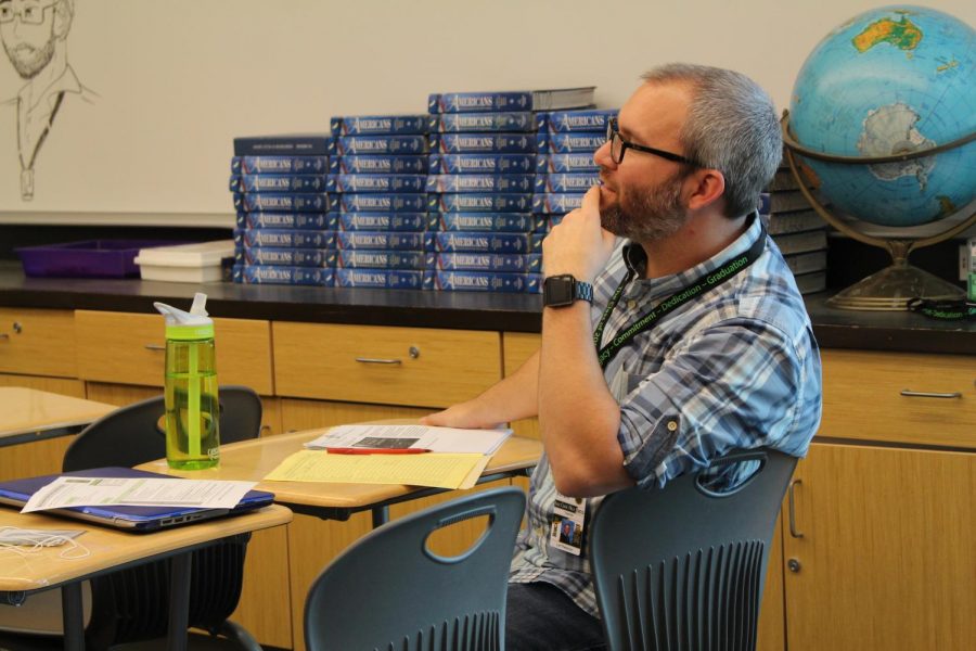 History teacher Leif Peterson listens to a student pitch their Genius Project to the class. On April 26, juniors and seniors alike presented their progress and shared advice on their projects to freshmen, sophomores, and each other.