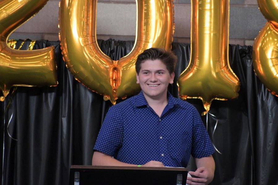 Darius Rahmanian up on stage in front of his class divulging all of the aspects about Sage Creek that he will miss and all that he among the rest of his peers have to look forward when leaving high school.