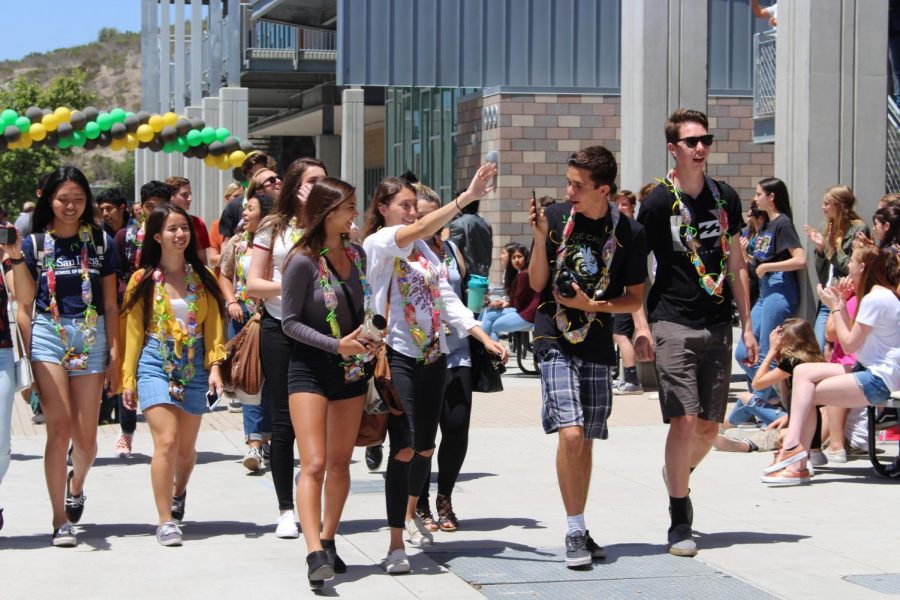 Students in Mrs. Andersson’s advisory class are applauded as they leave depart from the Sage Creek campus during the senior walk off.