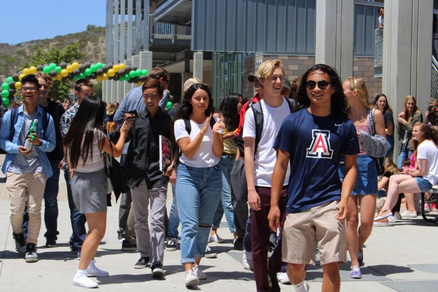 Nick Miyamoto leads the remainder of his advisory class towards the front gates of the school during their senior send off.