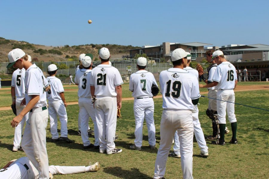  Baseball warms up to face off against their opponent in a home game at the Sage Creek field. The boys played as a team this year and said they had a fun season together.