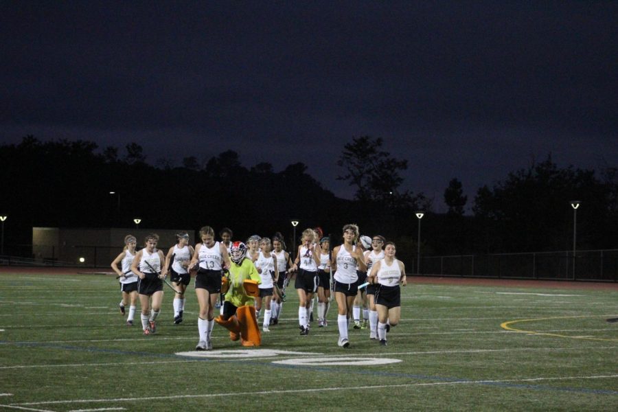 Sage Creek Field Hockey team sprints in after celebrating with the goalie. They completed a 4-0 sweep over El Cajon Valley.
