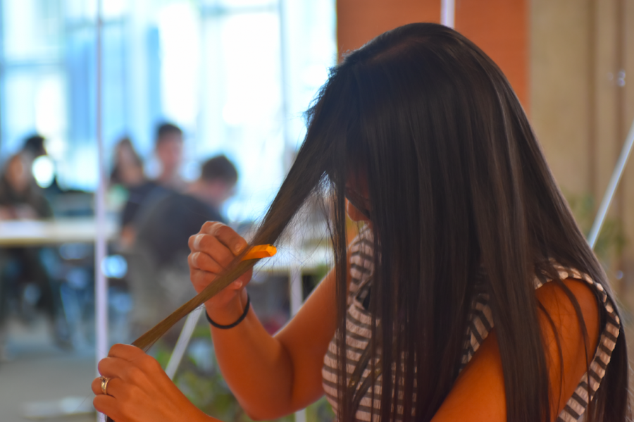 ASB Accounting Tech, Jocelyn South, dyes her hair alongside other staff members of the Sage Creek community to show their support for biomedical science teacher, Juli Bachman. At the beginning of lunch this past Wednesday the staff gathered together in the SCHS Library to dye sections of their hair with chalk.