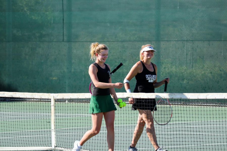 Sophomore Jackie Tucker walks alongside her opponent from Oceanside High School. After a tough match, Sage Creek’s girls tennis team ultimately took the victory.