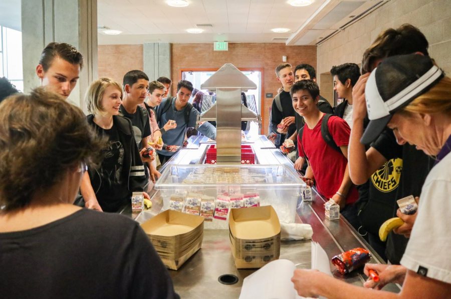 Seniors eagerly await steaming breakfast burritos inside the cafeteria. In keeping with tradition, a warm breakfast was served after the annual senior panoramic photo this past Wednesday, Oct. 10.