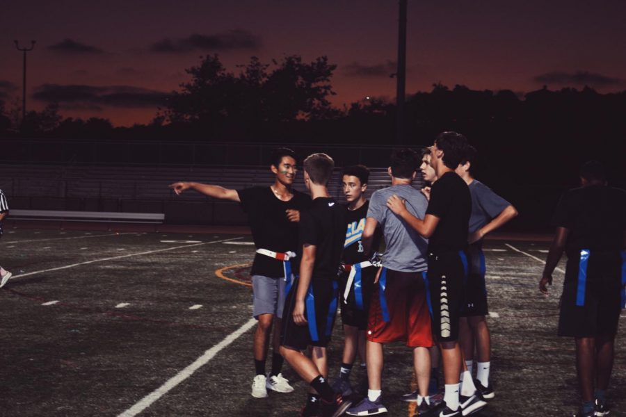 Sophomores Chris Welle and David Yoon huddle with their team before the game. Sage Creek's Flag Football Tournament is an annual event held by ASB in which students compete to eventually face off the Staff's team, "The Detention Room".