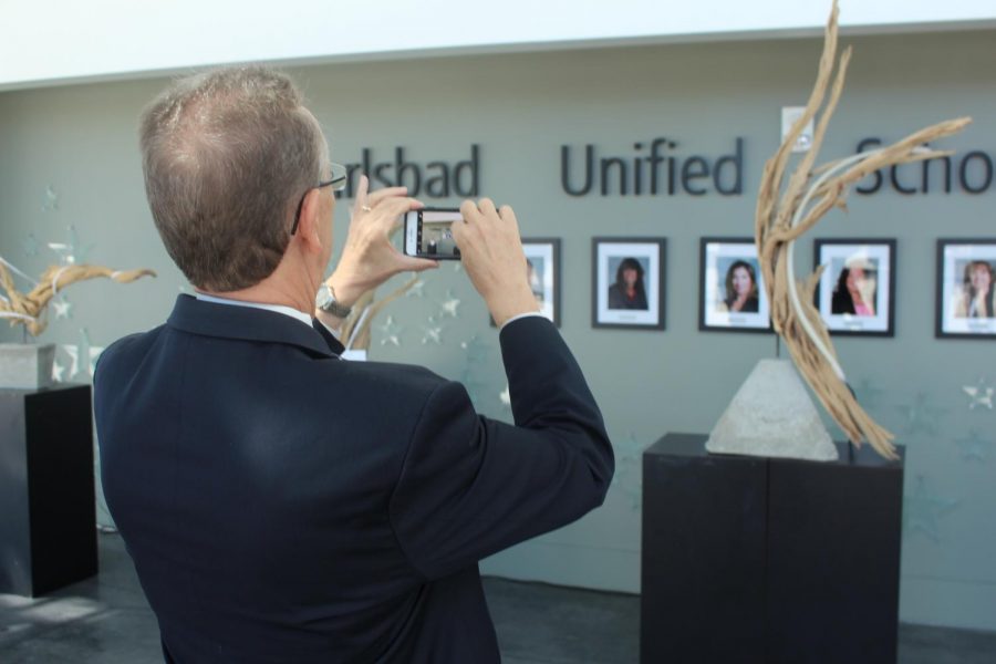 Ray Pearson snaps a picture of the photos of him and his fellow board
members in the PAC. Pearson is very proud of the work him and his colleagues have
done for the school district.