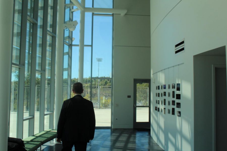 Pearson is walking through the PAC lobby. Pearson admires the beauty of
Sage Creek High School’s new visual and performing arts center.