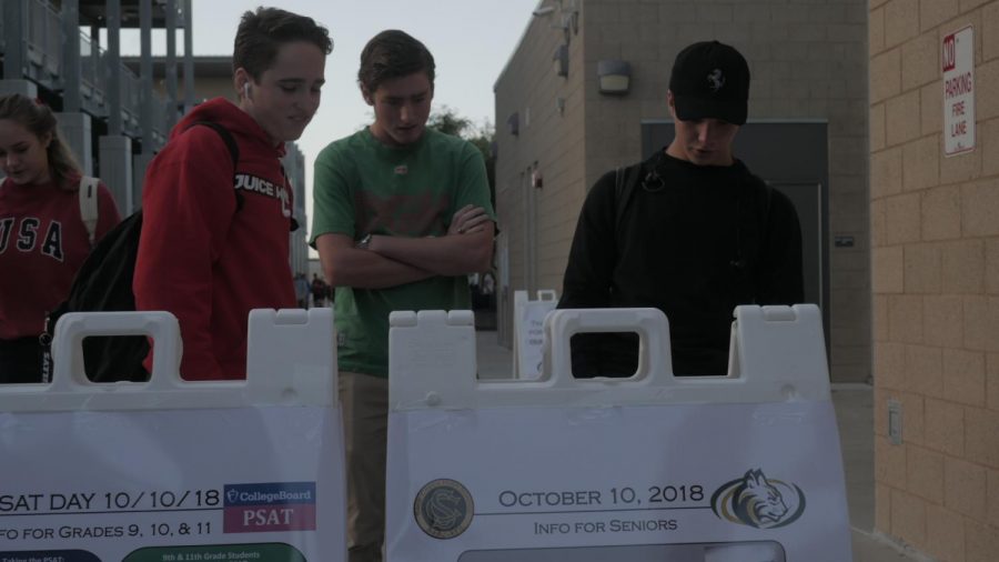 Students look at the schedule board on Oct. 10 in preparation of the rigours PSAT testing ahead. The PSAT was a nationwide test which, normally, is just a practice test for the SAT, but the PSAT can make you qualify for merit scholarships.