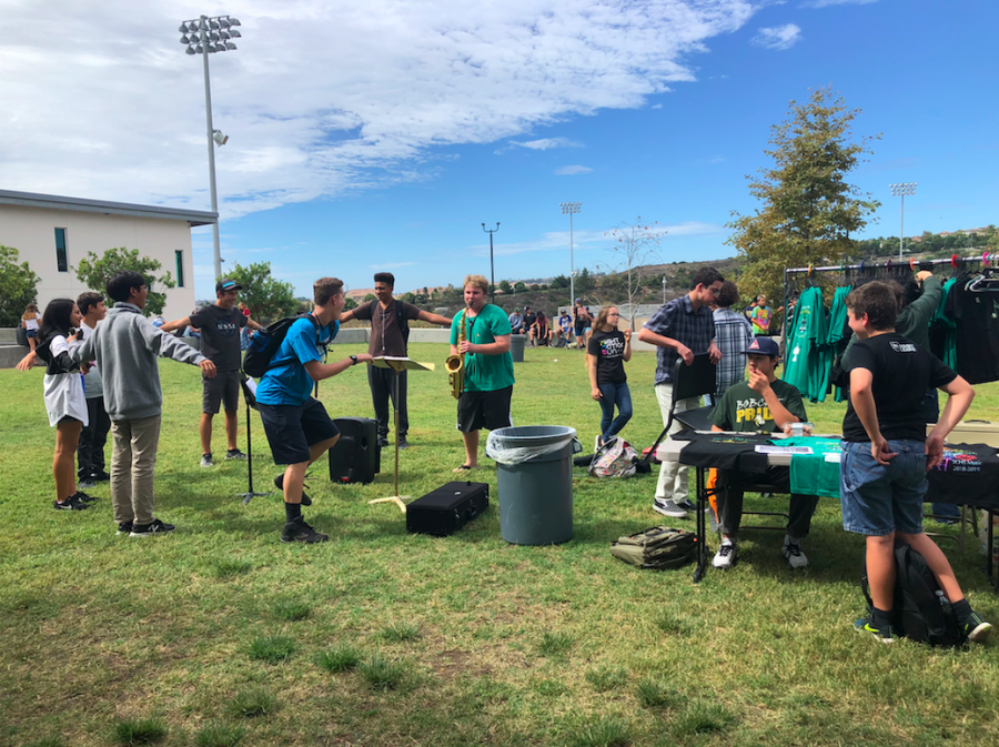 Students gather at the grassy area of the academic mall listening to a member of band play the saxophone. The first ever Music Monday was held on Oct. 1 with the purpose of getting more students involved in the musical programs at Sage Creek.