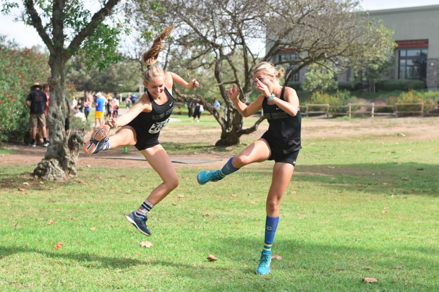 Juniors Addie Ebbs and Natalie Huestis jumping for joy for the varsity cross country girls win at the Central Park Invitational this past Saturday, Oct. 6. The team continues to be in high spirits with their continual success throughout this season.