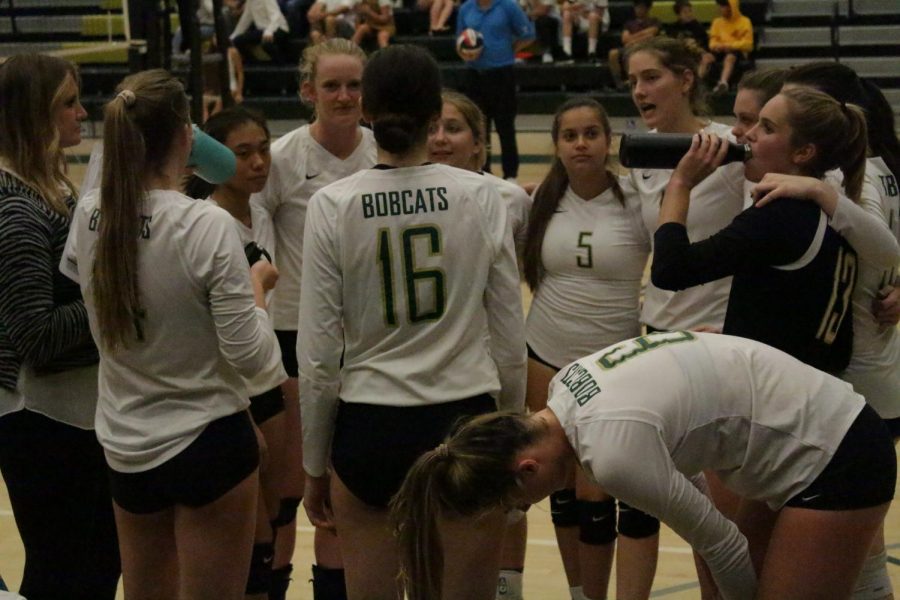 All huddled up, the girls varsity volleyball team gets together to discuss their previous plays and how they can improve throughout the rest of the game.  After the quick chat, the girls gained even more confidence and won the match. 